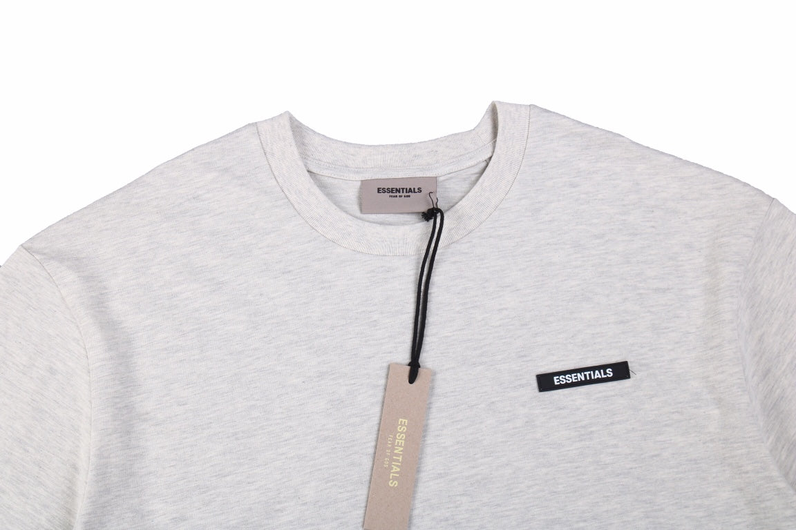Fear Of God Essentials Logo T-shirt - Heather - Grey Unisex Streetwear Limited Edition - This heather grey t-shirt from Fear of God Essentials showcases a soft, versatile color with