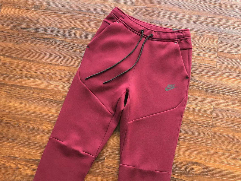 NIKE Tech Fleece Pants - Burgundy - Red Unisex Streetwear Limited Edition - The NIKE TECH FLEECE PANTS BURGUNDY - REPLICA bring together modern athletic performance and bold