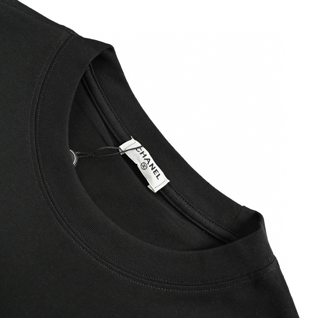 Chanel T-shirt - Black Unisex Streetwear Limited Edition - This Chanel t-shirt features a large, iconic double C logo graphic on the front. The