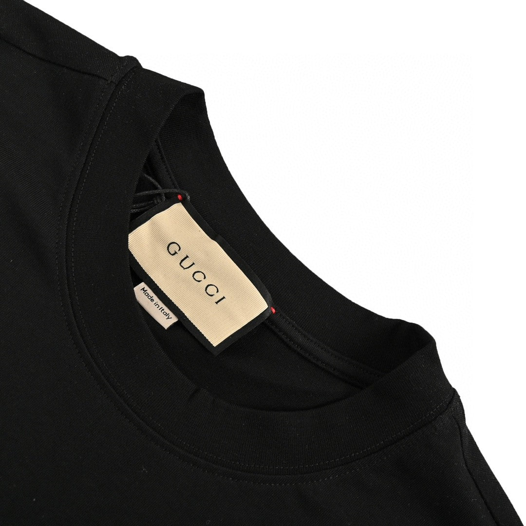 Gucci T-shirt - Black Unisex Streetwear Limited Edition - This Gucci t-shirt features a playful design with a small graphic of a cartoon face