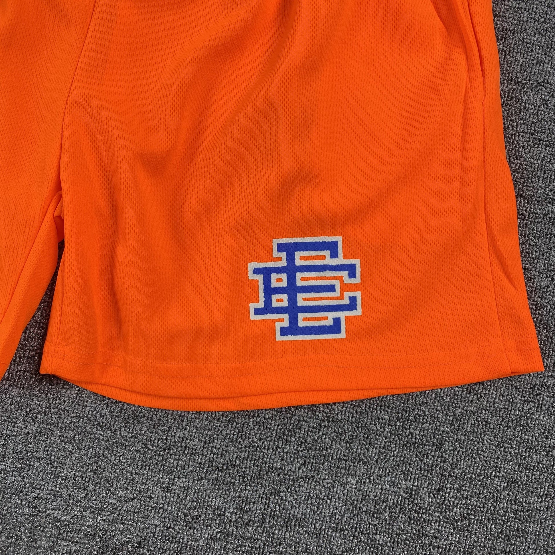 ERIC Emanuel Ee Basic Shorts Orange - - Blue Unisex Streetwear Limited Edition - The ERIC EMMANUEL EE BASIC SHORTS ORANGE/BLUE - REPLICA combine vibrant streetwear aesthetics with premium