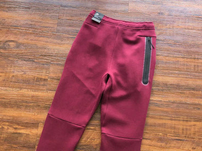 NIKE Tech Fleece Pants - Burgundy - Red Unisex Streetwear Limited Edition - The NIKE TECH FLEECE PANTS BURGUNDY - REPLICA bring together modern athletic performance and bold