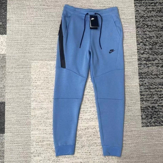 NIKE Tech Fleece Pants - Blue - White Unisex Streetwear Limited Edition - The NIKE TECH FLEECE PANTS BLUE WHITE - REPLICA merge modern athletic performance with sleek