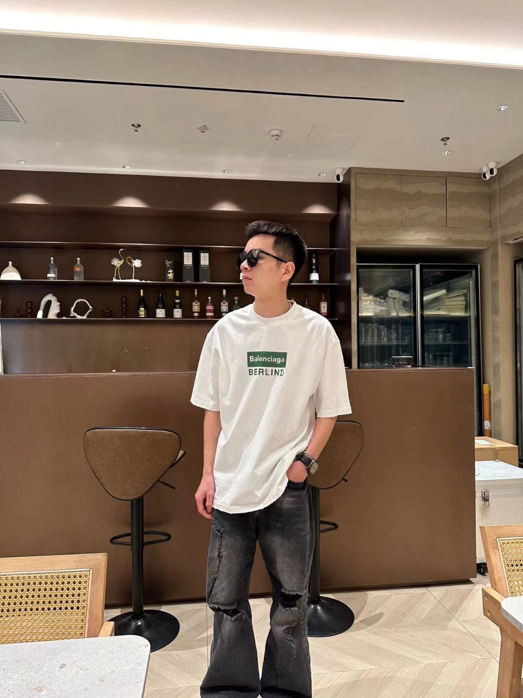 Balenciaga T-shirt - Berlin Graphic - White Unisex Streetwear Limited Edition - <span>This Balenciaga t-shirt features a minimalist design with the text 'Balenciaga' inside a green rectangular
