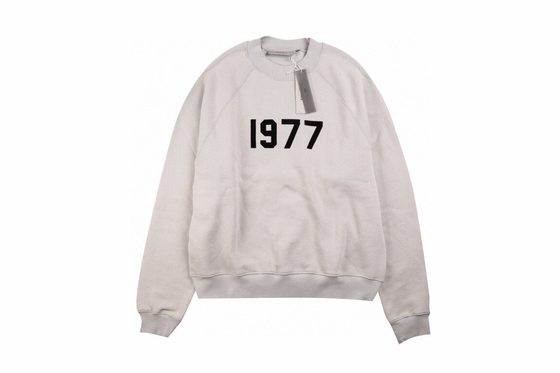 Fear Of God Essentials '1977' Sweatshirt - Grey Unisex Streetwear Limited Edition - This Fear of God Essentials sweatshirt features a minimalist design with the bold '1977' graphic