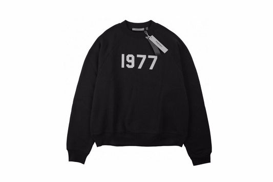 Essentials Sweatshirt - Black Unisex Streetwear Limited Edition - Black sweatshirt with white '1977' print on the chest. Classic crewneck design. Comfortable and perfect