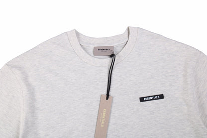 Fear Of God Essentials Logo T-shirt - Heather - Grey Unisex Streetwear Limited Edition - This heather grey t-shirt from Fear of God Essentials showcases a soft, versatile color with