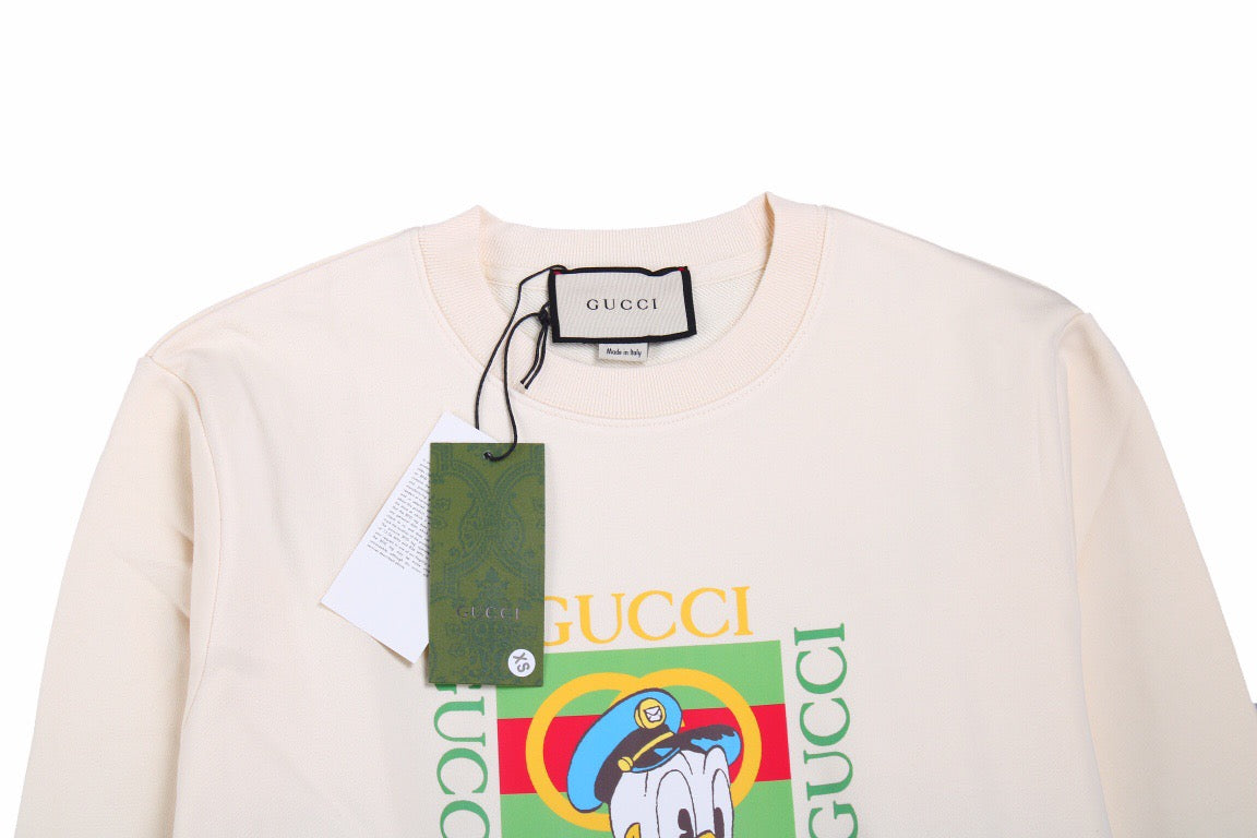 Gucci Donald Duck Sweatshirt - - Cream Unisex Streetwear Limited Edition - This cream-colored Gucci sweatshirt features a playful graphic of Donald Duck paired with the iconic