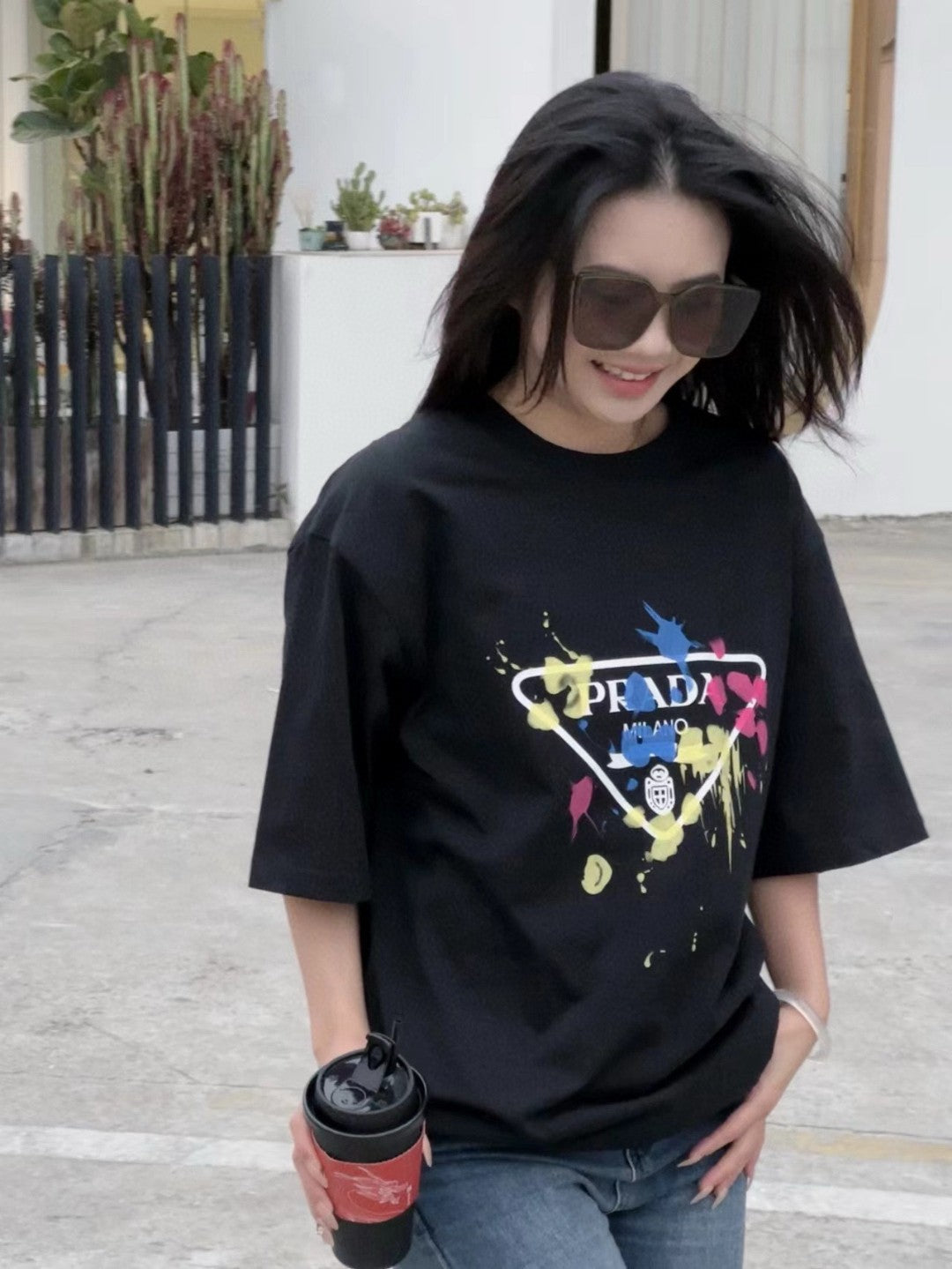 Prada T-shirt - Paint Splatter Logo - Black Unisex Streetwear Limited Edition - <span>This Prada t-shirt features a unique design with the classic Prada Milano logo surrounded by