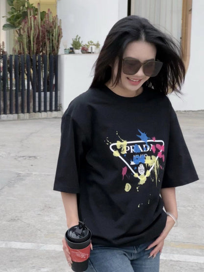 Prada T-shirt - Paint Splatter Logo - Black Unisex Streetwear Limited Edition - <span>This Prada t-shirt features a unique design with the classic Prada Milano logo surrounded by