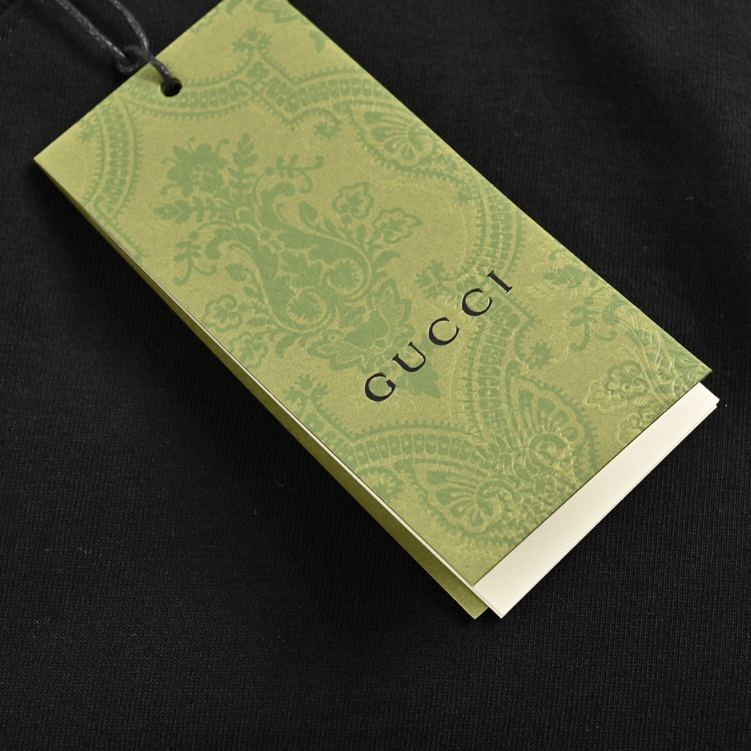 Camiseta negra de Gucci con estampado de dinosaurio rosa