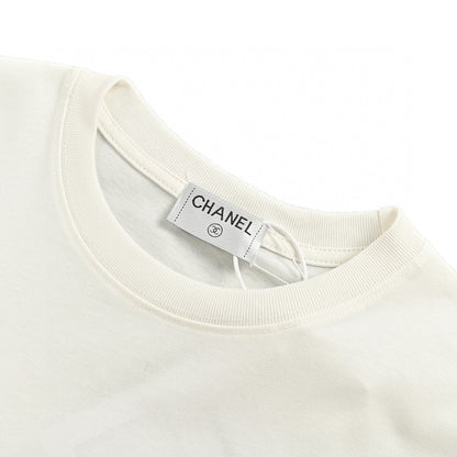 Chanel T-shirt - White Unisex Streetwear Limited Edition - This Chanel t-shirt features a minimalist white design. It has a subtle graphic on the