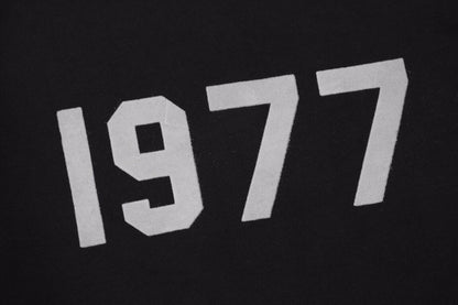Essentials Sweatshirt - Black Unisex Streetwear Limited Edition - Black sweatshirt with white '1977' print on the chest. Classic crewneck design. Comfortable and perfect