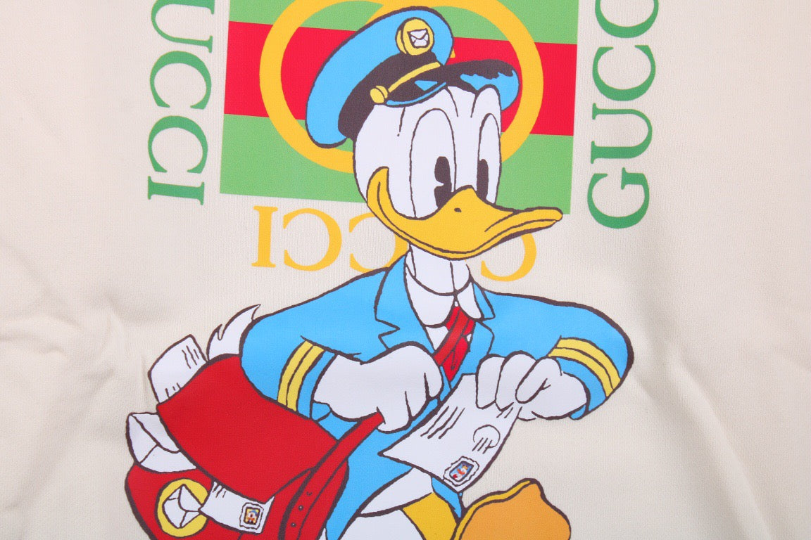 Gucci Donald Duck Sweatshirt - - Cream Unisex Streetwear Limited Edition - This cream-colored Gucci sweatshirt features a playful graphic of Donald Duck paired with the iconic