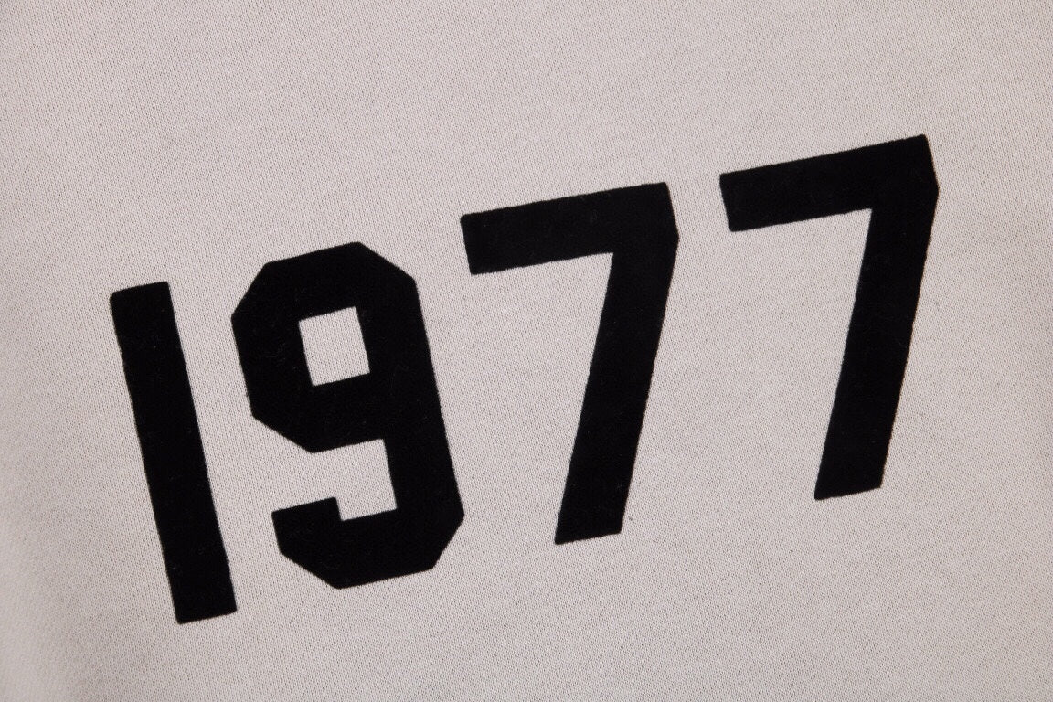Fear Of God Essentials '1977' Sweatshirt - Grey Unisex Streetwear Limited Edition - This Fear of God Essentials sweatshirt features a minimalist design with the bold '1977' graphic
