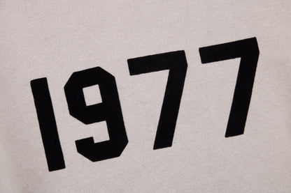 Fear Of God Essentials '1977' Sweatshirt - Grey Unisex Streetwear Limited Edition - This Fear of God Essentials sweatshirt features a minimalist design with the bold '1977' graphic