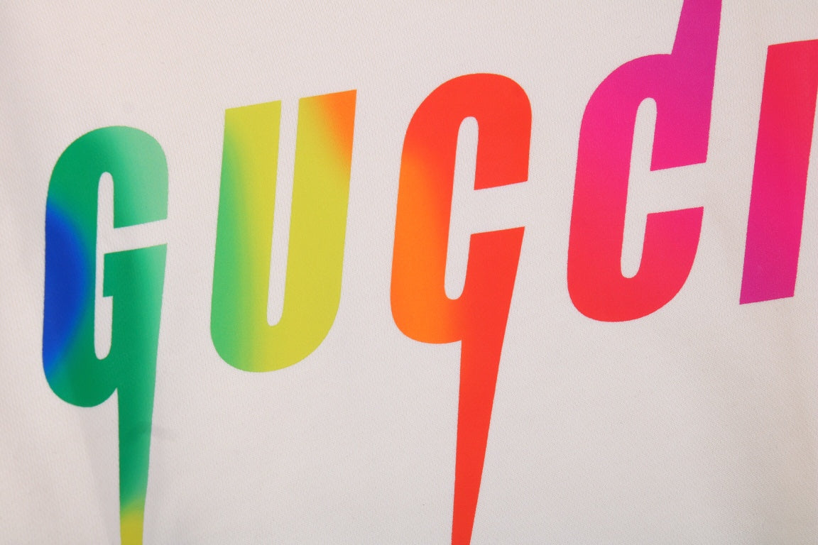 Gucci Rainbow Logo Hoodie - - Cream Unisex Streetwear Limited Edition - This cream-colored Gucci hoodie features a striking rainbow 'GUCCI' logo on the front. It has