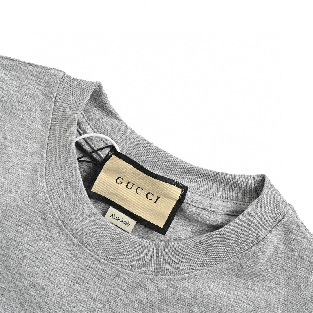 Gucci Cartoon Graphic T-shirt (grey) Unisex Streetwear Limited Edition - This grey Gucci T-shirt features a playful and vibrant cartoon graphic design. The front showcases