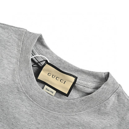 Gucci Cartoon Graphic T-shirt (grey) Unisex Streetwear Limited Edition - This grey Gucci T-shirt features a playful and vibrant cartoon graphic design. The front showcases