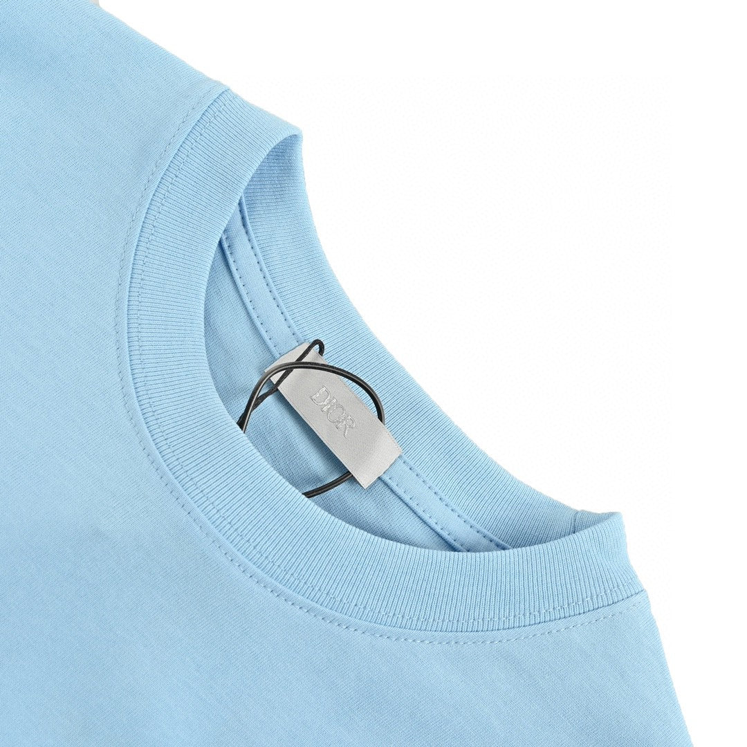 Dior Christian Dior Couture Light T-shirt - Blue Unisex Streetwear Limited Edition - This Dior t-shirt features a minimalist design with 'Christian Dior Couture' text in orange on