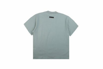 Fear Of God Essentials T-shirt - Green Unisex Streetwear Limited Edition - <p dir='ltr'><span>A minimalist Fear of God Essentials t-shirt. Light green color with 'ESSENTIALS' text