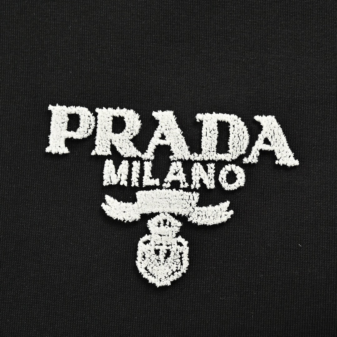 Prada T-shirt - Black Unisex Streetwear Limited Edition - This Prada t-shirt features a minimalist black design. It has the Prada Milano logo printed