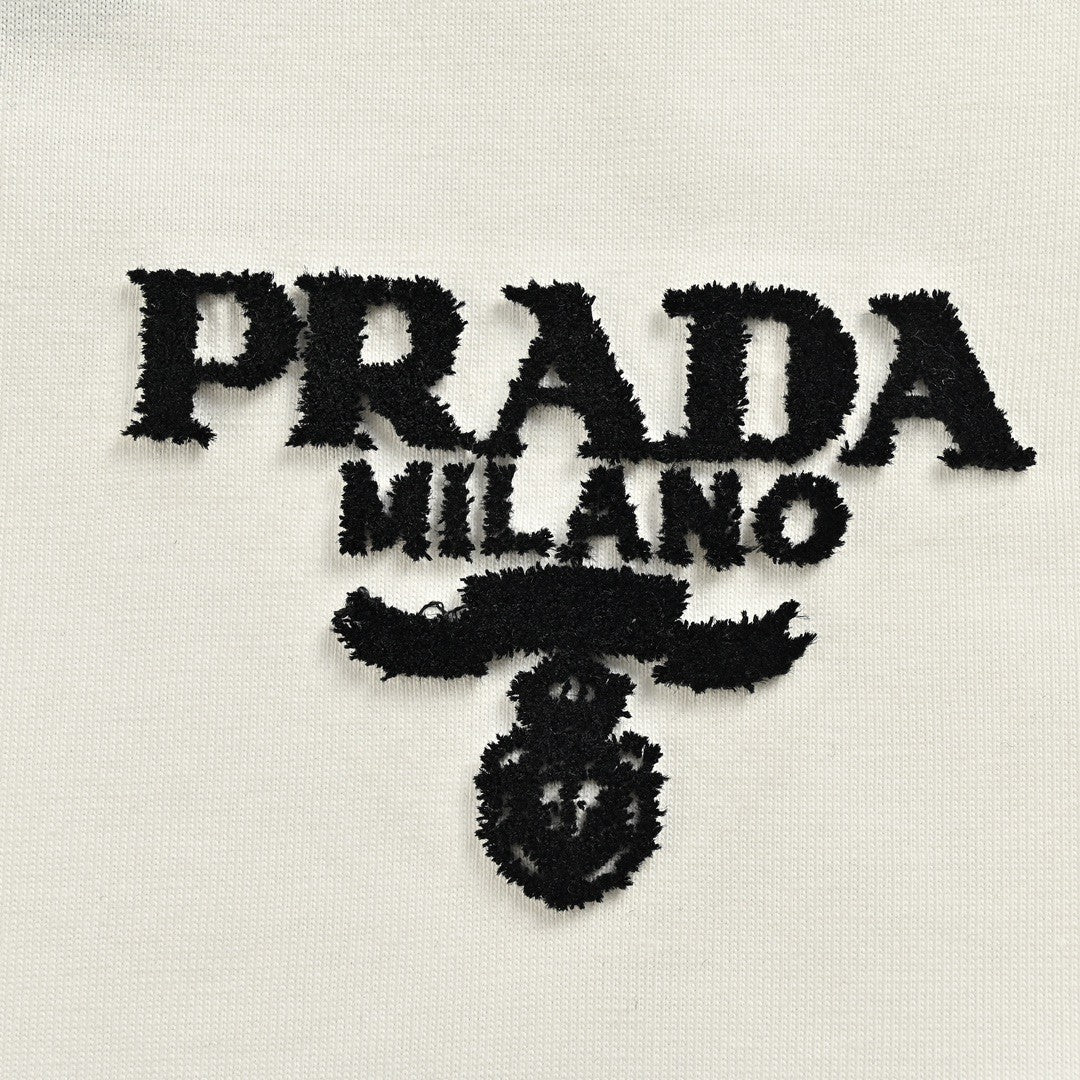 Prada T-shirt - Black Unisex Streetwear Limited Edition - This Prada t-shirt features a minimalist white design. It has the Prada Milano logo printed