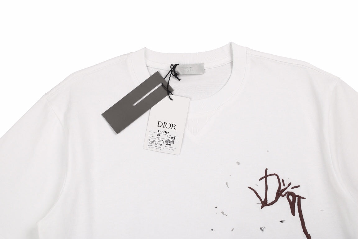 Dior T-shirt With Logo - Brown Unisex Streetwear Limited Edition - <p dir='ltr'><span>White t-shirt featuring a brown Dior logo with a splattered paint effect. Bold