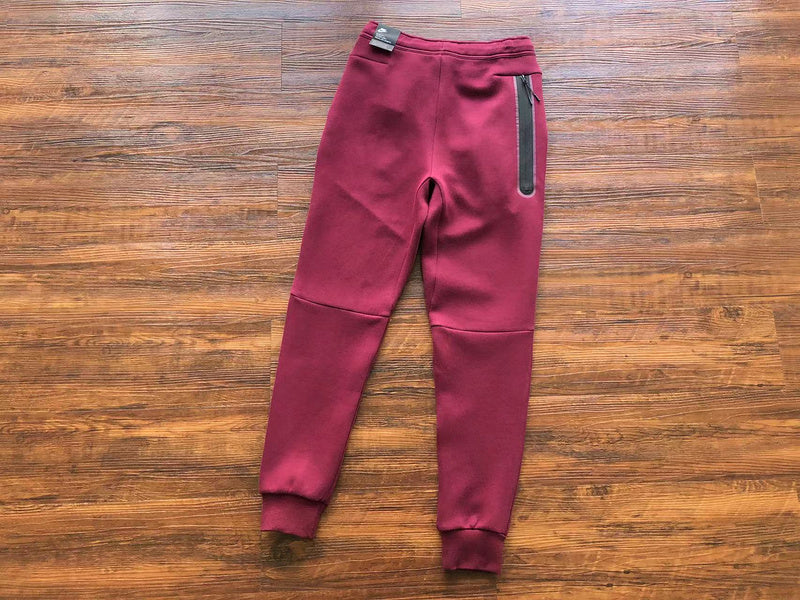 NIKE Tech Fleece Pants - Burgundy - Red Unisex Streetwear Limited Edition - The NIKE TECH FLEECE PANTS BURGUNDY - REPLICA bring together modern athletic performance and bold