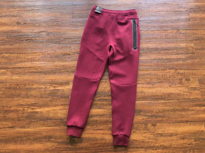 NIKE Tech Fleece Pants - Burgundy - Red Unisex Streetwear Limited Edition - The NIKE TECH FLEECE PANTS BURGUNDY - REPLICA bring together modern athletic performance and bold