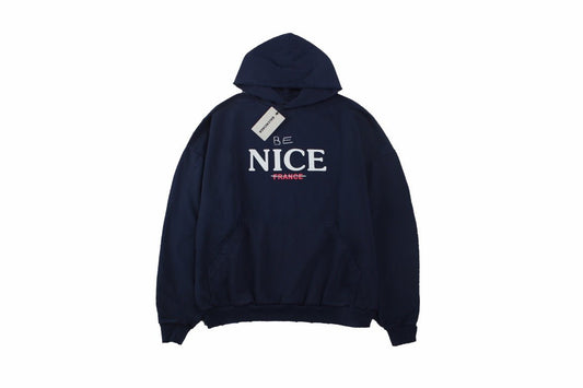 Balenciaga 'be Nice' Hoodie - Blue Unisex Streetwear Limited Edition - This Balenciaga hoodie features a playful 'Be Nice' slogan with 'France' crossed out beneath it.