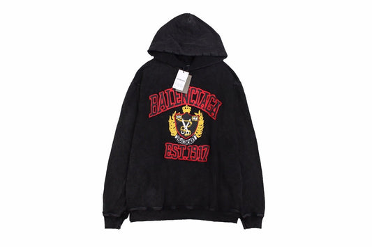 Balenciaga Crest Hoodie - Black Unisex Streetwear Limited Edition - This Balenciaga hoodie features a prominent crest design in red and gold, highlighting the brand's