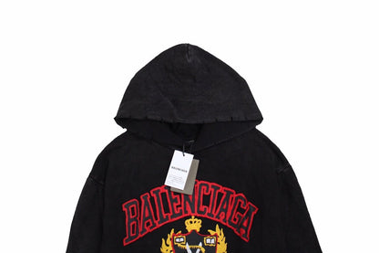 Balenciaga Crest Hoodie - Black Unisex Streetwear Limited Edition - This Balenciaga hoodie features a prominent crest design in red and gold, highlighting the brand's