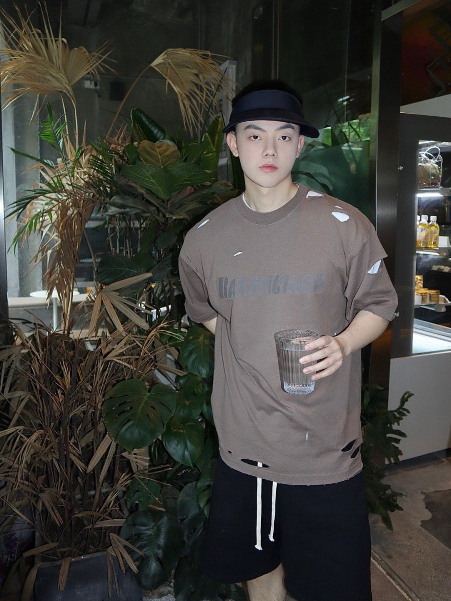 Balenciaga Distressed Logo T-shirt Unisex Streetwear Limited Edition - <span>This Balenciaga t-shirt features a muted taupe design with intentional distressed details, providing a trendy,