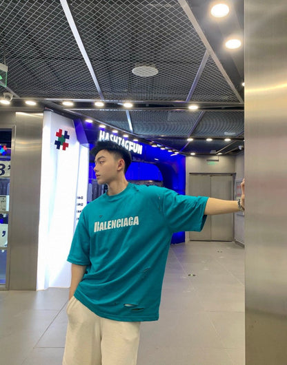 Balenciaga Distressed Logo T-shirt Unisex Streetwear Limited Edition - <span>This Balenciaga t-shirt features a vibrant turquoise design with intentional distressed details, giving it a